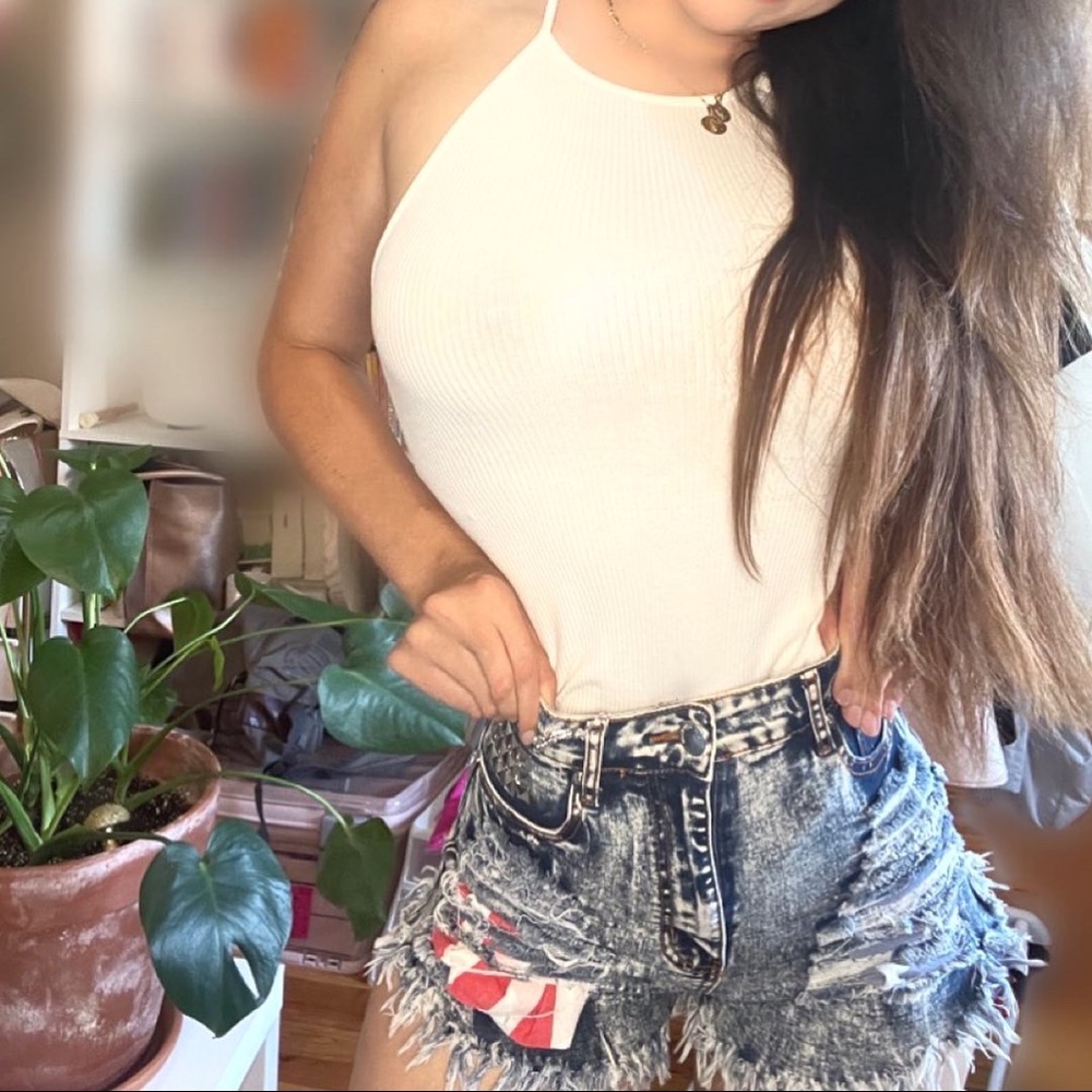 Studded distressed high waisted denim shorts with detailed pockets